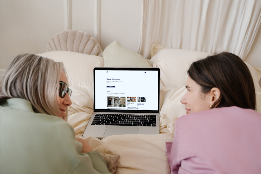 Picture of two ladies on the bed reading the news on Ipswich.co.uk on their laptop